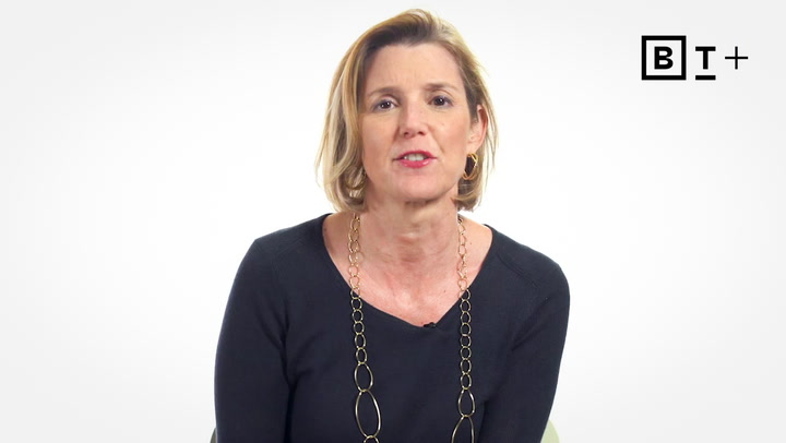 A woman with short blonde hair and a black top sits in front of a white background with a "BT+" logo in the top right corner.