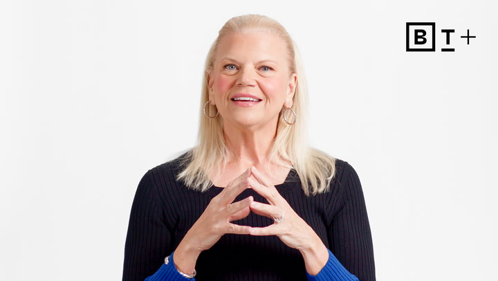 A woman with blonde hair, wearing a black top and hoop earrings, speaks while gesturing with her hands; the BT+ logo appears in the top right corner.