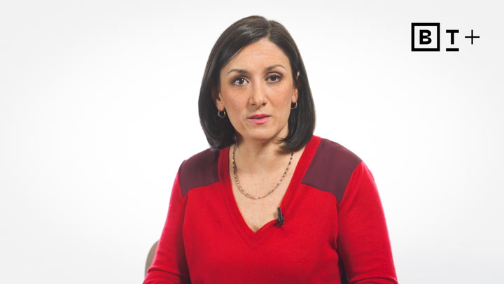 A woman with straight dark hair wearing a red top sits against a plain white background with a "B T +" logo in the top right corner.