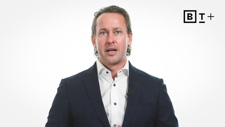 Man in a dark suit and white shirt speaks while facing the camera; BT+ logo appears in the top right corner against a white background.
