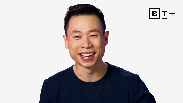 A man with short dark hair wearing a dark shirt smiles at the camera in front of a plain white background with the "B T+" logo in the top right corner.