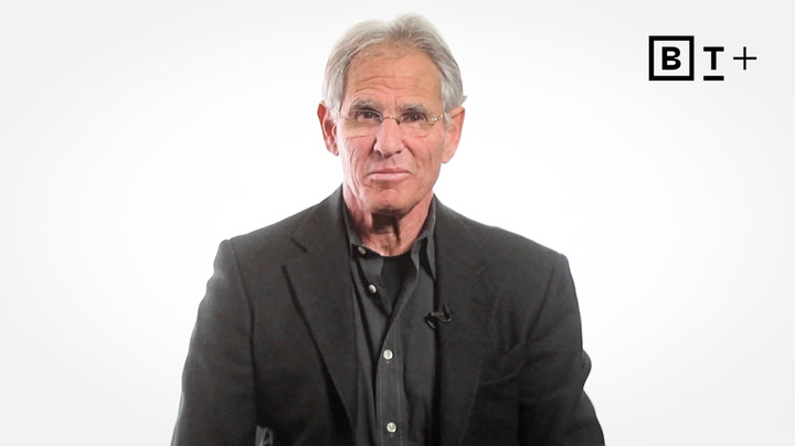 A man in a black suit.