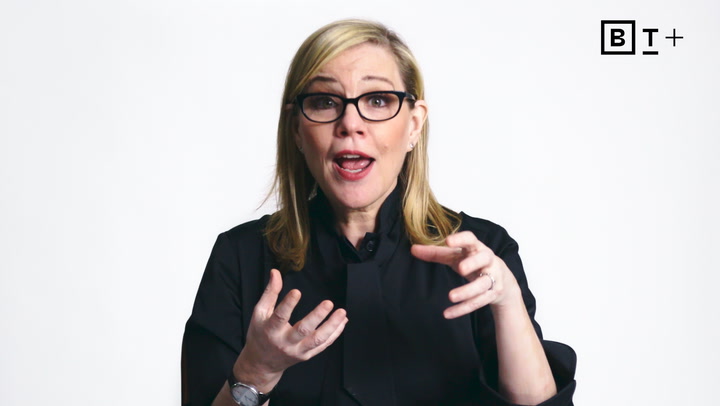 A woman with blonde hair and glasses speaks animatedly, gesturing with her hands, against a plain white background with a BT+ logo in the top right corner.
