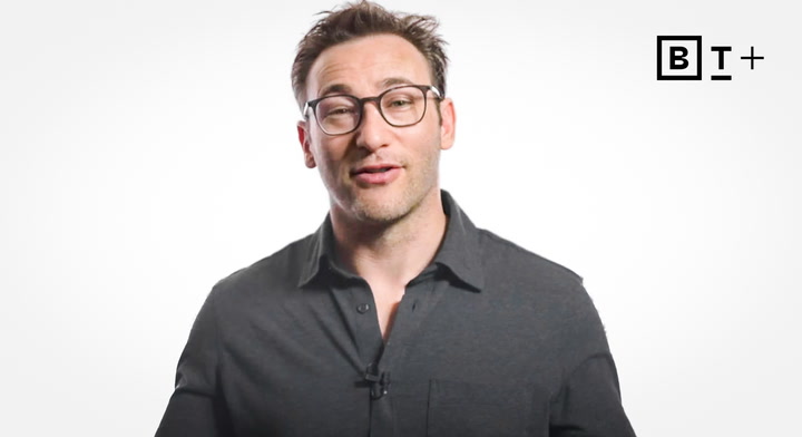 A person wearing glasses and a dark shirt stands in front of a plain white background with a "B T+" logo in the top right corner.