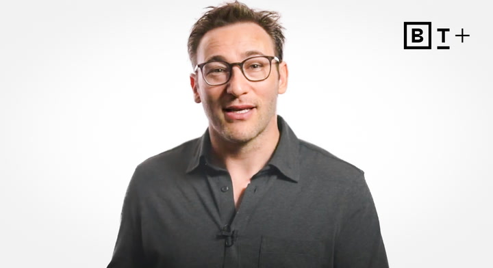 A man with glasses and a dark shirt stands against a plain white background with a "B T+" logo in the top right corner.