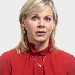 A woman with blonde hair wearing a red blouse, silver earrings, and a necklace is looking slightly upward against a plain light background.