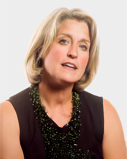 A woman with short blond hair, wearing a black sleeveless top and a dark beaded necklace, is looking slightly to the side against a plain light background.