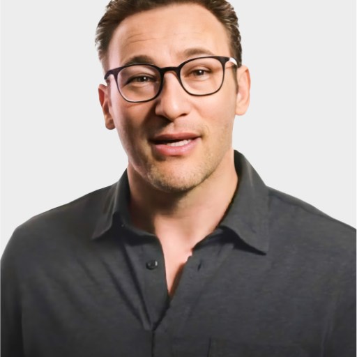 A man with short brown hair and glasses wearing a dark button-up shirt stands against a plain light background.