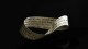 A Möbius strip made from paper with printed text is displayed against a dark background.